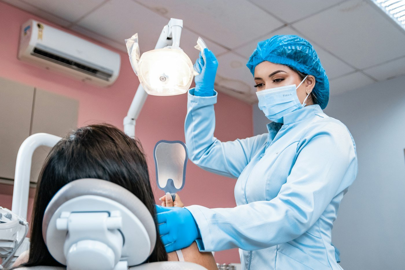 A dentist examining a patient's teeth during a consultation