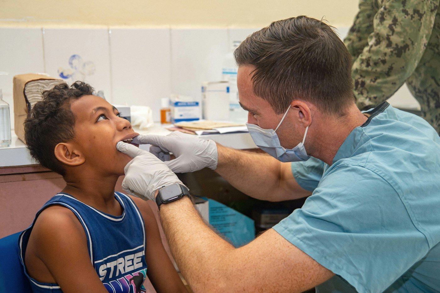 A dentist gently examining a child's teeth